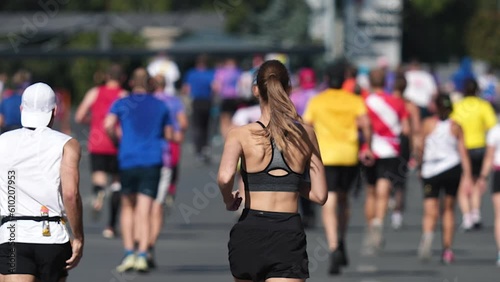 Female runner jog sport marathon. Woman athlete running long distance. Girl jogger work out urban public park. Sportswoman train body. Health city life concept. Fast race slow motion. Active fit track photo