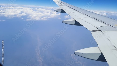 flight window view in air with hazy cloudy sky morning video taken at vistara flight from delhi to guwahati in india on Mar 05 2022. photo