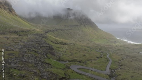 aerial shot driving along the famous winding road that leads to Norðradalur in the Faroe Islands. photo