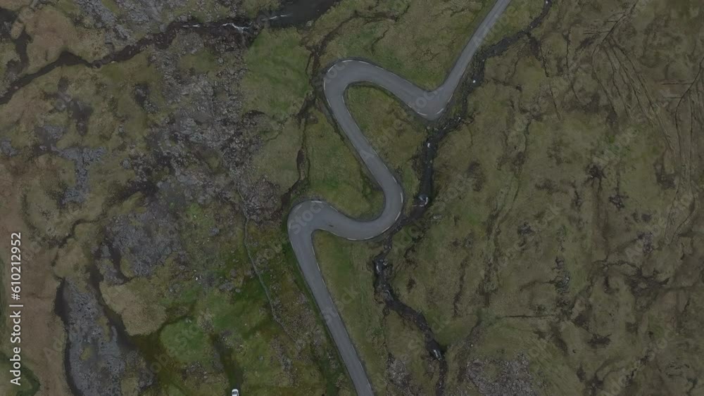 fantastic aerial shot from above over the famous winding road that leads to Norðradalur in the Faroe Islands. fantastic aerial shot from above over the famous winding road that leads to Norðradalur in the Faroe Islands.