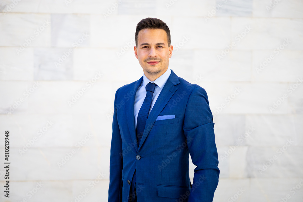 Young smiling business man wearing modern suit posing isolated on white background. Handsome economist, lawyer, CEO, entrepreneur, executive director and businessman looking at camera. Copy space. Young smiling business man wearing modern suit posing isolated on white background. Handsome economist, lawyer, CEO, entrepreneur, executive director and businessman looking at camera. Copy space.