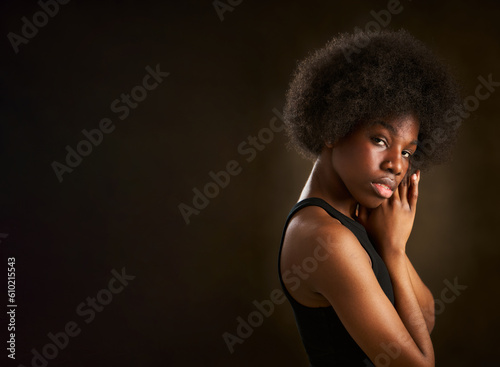 portrait of an attractive and empowered young black woman with a confident and seductive gaze © Retamosa