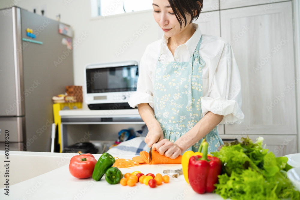 野菜を切る若い女性　料理イメージ