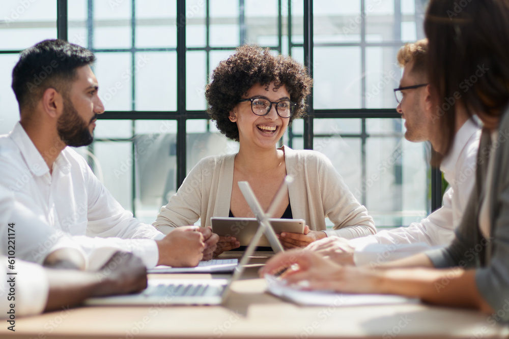 Fototapeta premium Employees working at computer together, discussing content