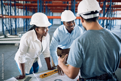 People  architect and blueprint in team construction  planning or architecture layout on site. Engineer group or contractor in meeting discussion on floor plan  brainstorming or building strategy