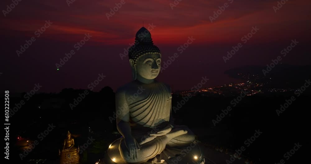 aerial view day to night amazing sky view at Phuket big Buddha ..important and revered landmarks on hill top of Phuket island..colorful red cloud in purple sky beautiful nature background