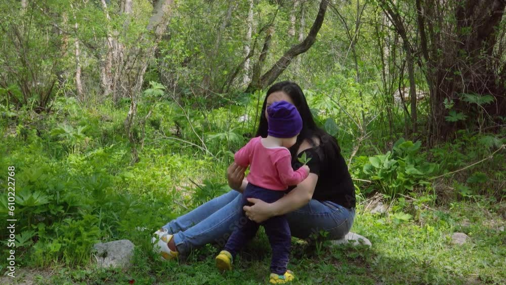 Mom and daughter are relaxing in nature