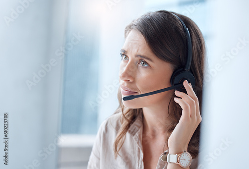 Worry, call center and woman with telemarketing, customer service and stressed in a workplace. Female person, employee or agent with headphones, tech support and help desk with advice or mistake photo