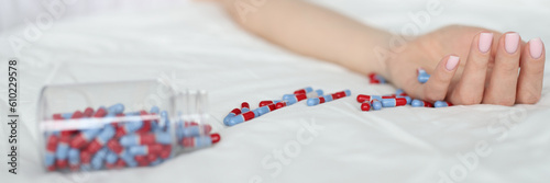 Overdose pills and drug addict background. Woman sleeps unconscious after eating pills on bed. Commits suicide and drug overdose concept