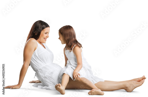 Happy mother and her cute daughter in white dress