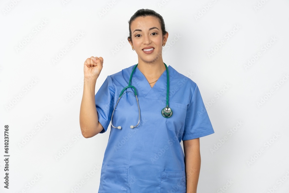 Young doctor woman wearing blue uniform over isolated background pointing up with fingers number nine in Chinese sign language Jiu Young doctor woman wearing blue uniform over isolated background pointing up with fingers number nine in Chinese sign language Jiu