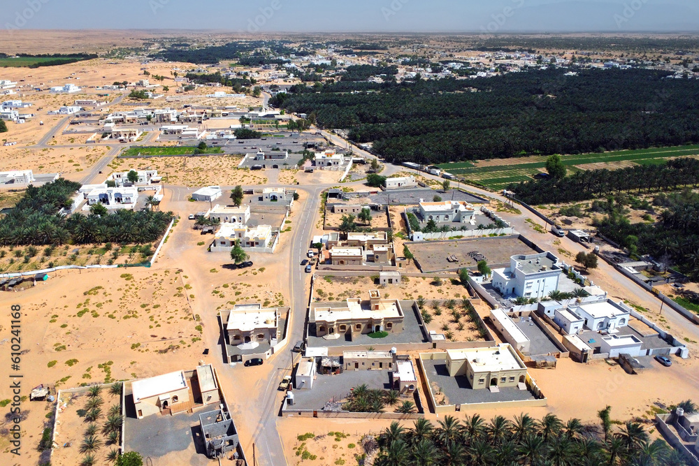 Obraz premium Aerial view of the city Falaj al Mashayikh on sunny day. City on the edge of the desert. Sultanate of Oman