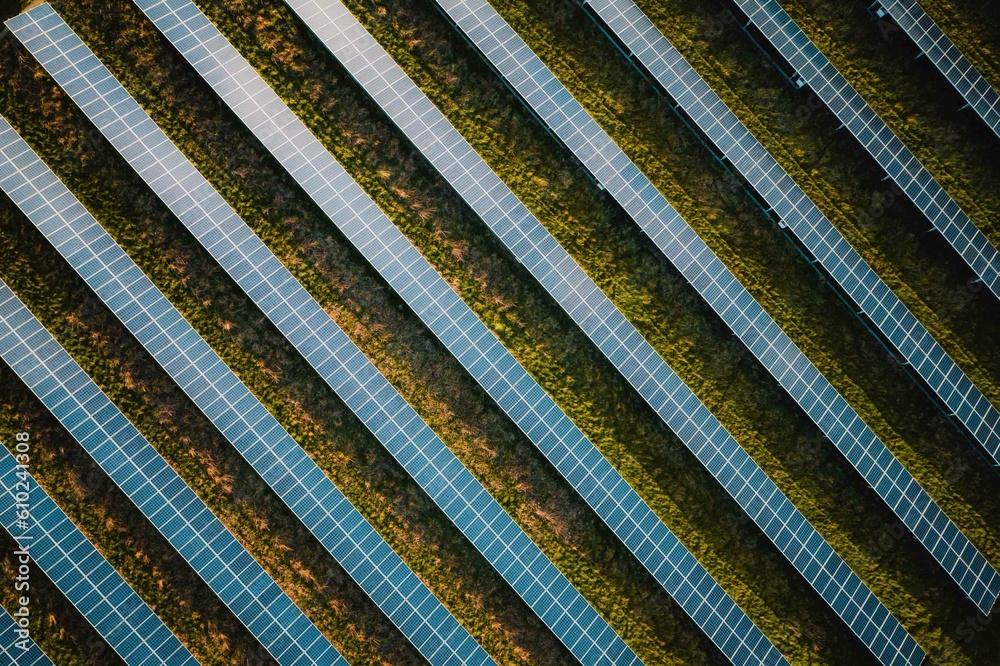 Solar panel rows aerial view. Photovoltaic panels farm from the sky, diagonal rows for renewable solar energy. Reducing carbon footprint concept, clean green energy for the future. Solar panel rows aerial view. Photovoltaic panels farm from the sky, diagonal rows for renewable solar energy. Reducing carbon footprint concept, clean green energy for the future.