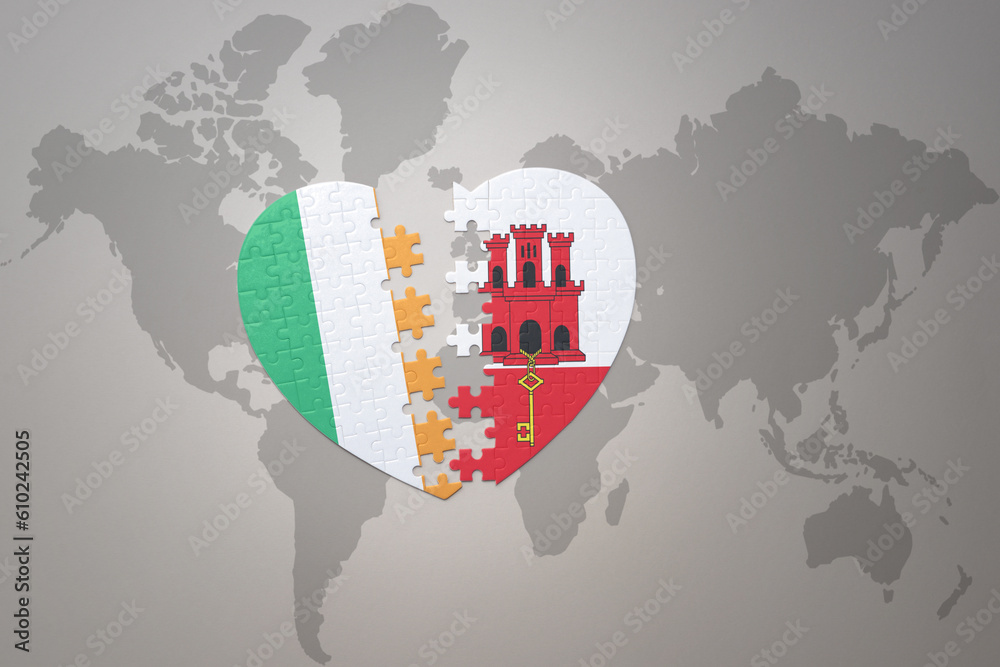 puzzle heart with the national flag of gibraltar and ireland on a world map background.Concept. puzzle heart with the national flag of gibraltar and ireland on a world map background.Concept.