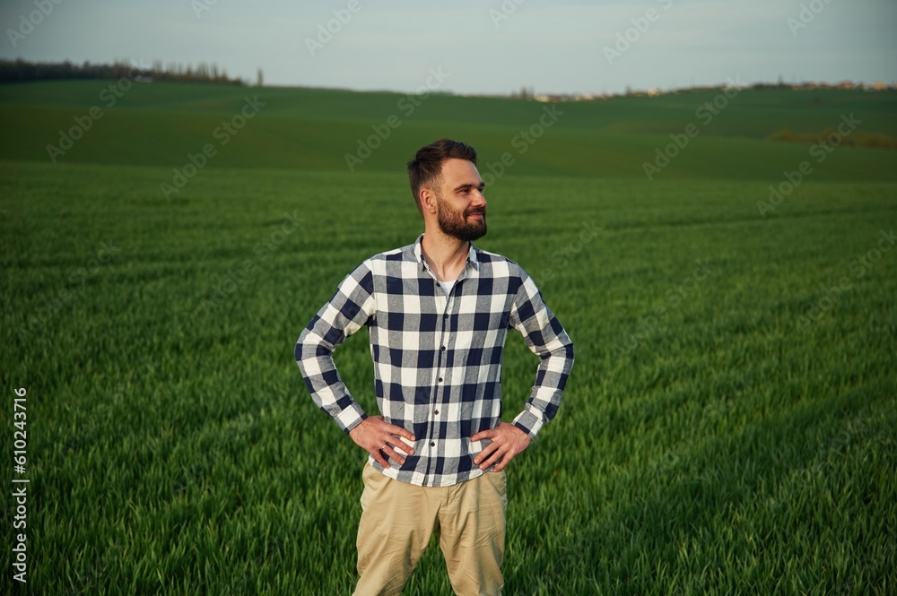 Spring season. Handsome young man is on agricultural field
