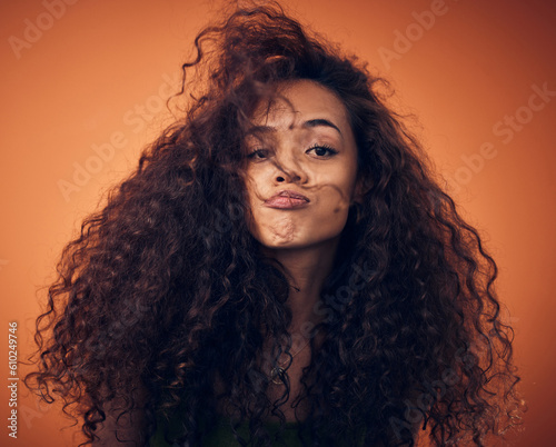 Portrait  beauty and woman with hair care  curly and volume against a studio background. Face  female person and model with salon treatment  wavy and grooming with cosmetics for hairstyle and growth
