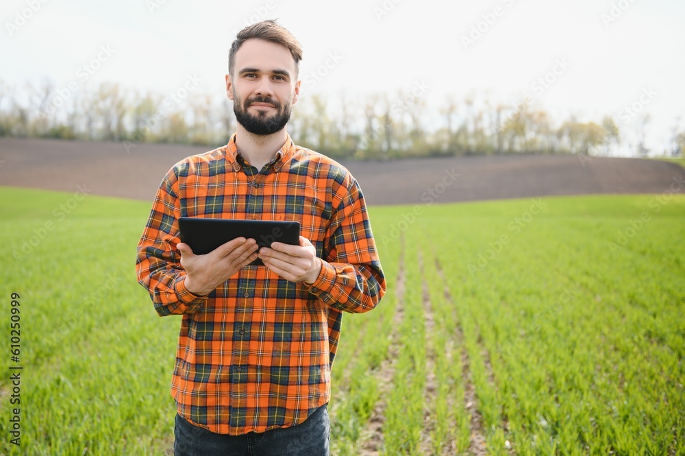 Portrait of farmer standing in field.