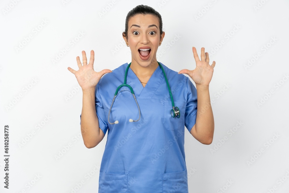 Optimistic Beautiful doctor woman standing over white studio background raises palms from joy, happy to receive awesome present from someone, shouts loudly, Optimistic Beautiful doctor woman standing over white studio background raises palms from joy, happy to receive awesome present from someone, shouts loudly,