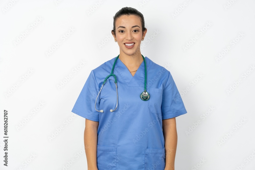 Beautiful doctor woman standing over white studio background with nice beaming smile pleased expression. Positive emotions concept Beautiful doctor woman standing over white studio background with nice beaming smile pleased expression. Positive emotions concept
