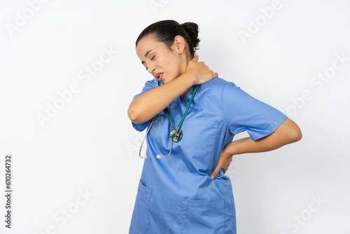Beautiful doctor woman standing over white studio background got back pain