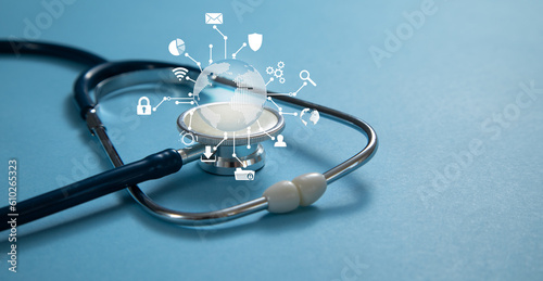 Fototapeta Naklejka Na Ścianę i Meble -  Stethoscope with a globe on the blue background.
