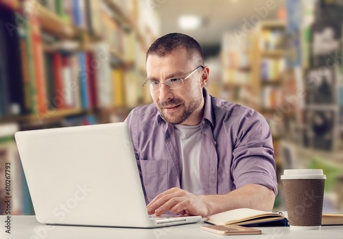 Happy young business man using laptop