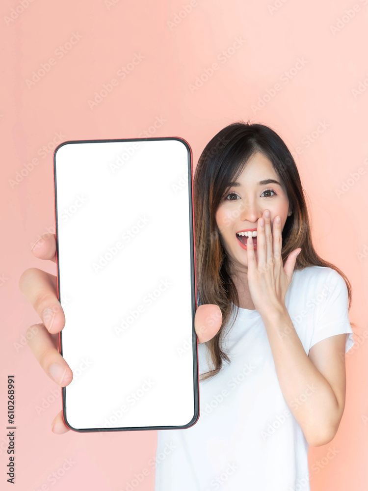 beautiful Asian young woman showing big smart phone with blank screen , white screen empty copy space for advertising banner isolated on pink background , Mock Up Image beautiful Asian young woman showing big smart phone with blank screen , white screen empty copy space for advertising banner isolated on pink background , Mock Up Image