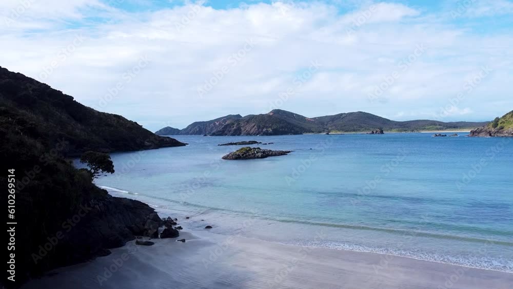 Aerial drone view of rocky outcrop and beautiful turquoise ocean water in Matai Bay, Karikari Peninsula in New Zealand Aotearoa