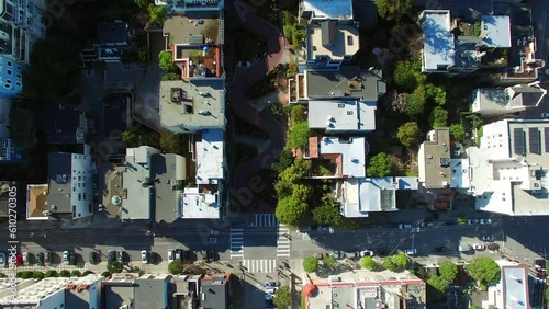 Aerial Top View Of Lombard Street Amidst Buildings In City, Drone Flying Forward Over Neighborhood On Sunny Day - San Francisco, California