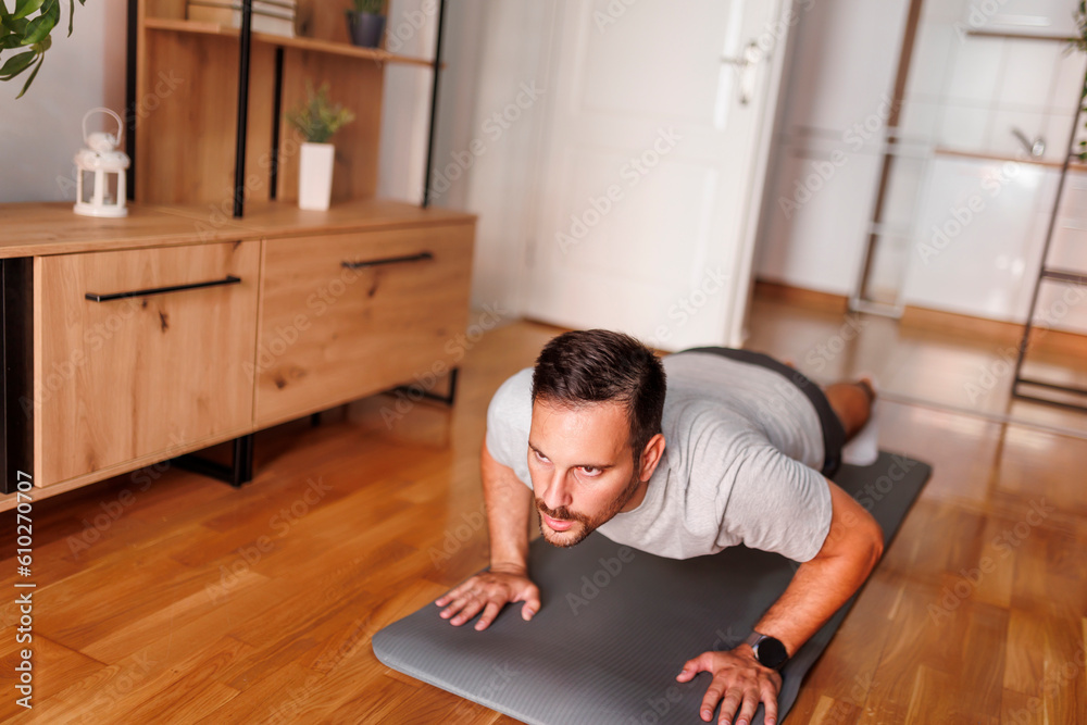 Fototapeta premium Man doing push ups while doing home workout