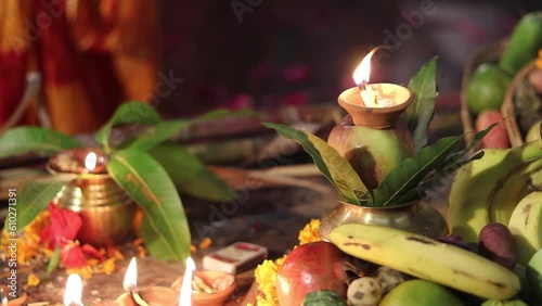 burning oil lamp with offerings during holy rituals at festival from different angle video is taken on the occasions of chhath festival which is used to celebrate in north india on Oct 28 2022. photo
