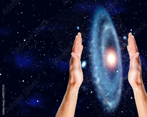 Cosmic Energy concept - male hands and night sky