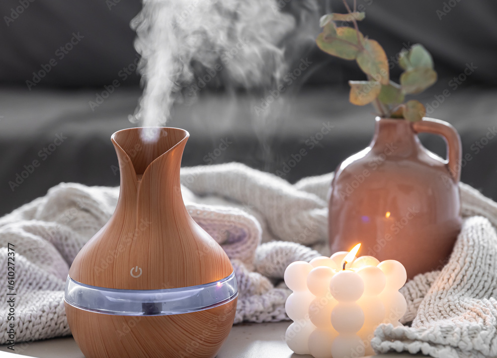 Obraz premium Spa composition with aroma oil diffuser lamp and candle on a blurred background.