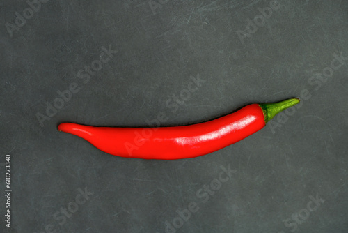 One red hot chili pepper on black background