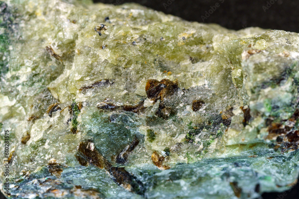 Rock with peridot olivine mineral, black background. Close-up, macro Rock with peridot olivine mineral, black background. Close-up, macro