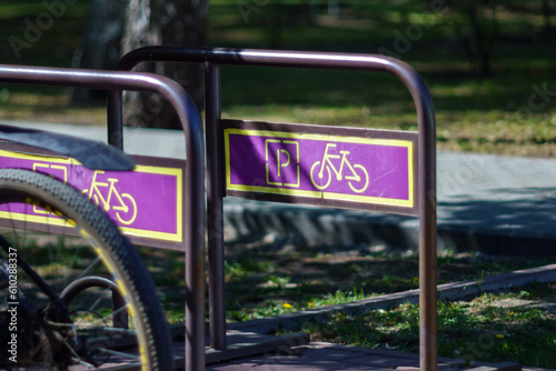 Bicycle parking in the parking lot. Summer day, selective focus
