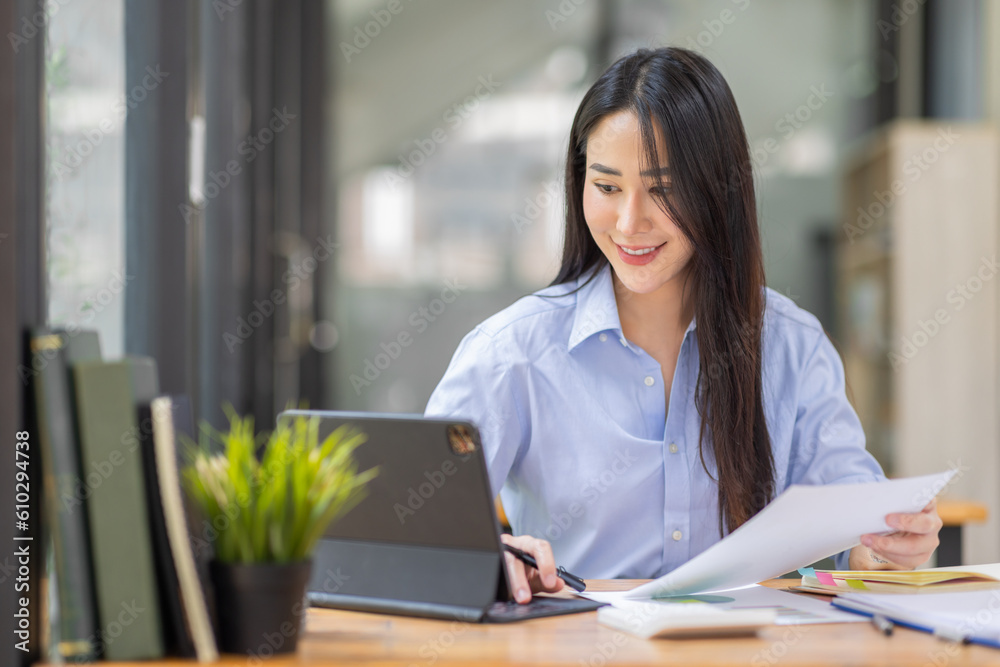 Asian Business woman using calculator and laptop for doing math finance on an office desk, tax, report, accounting, statistics, and analytical research concept
Asian Business woman using calculator and laptop for doing math finance on an office desk, tax, report, accounting, statistics, and analytical research concept