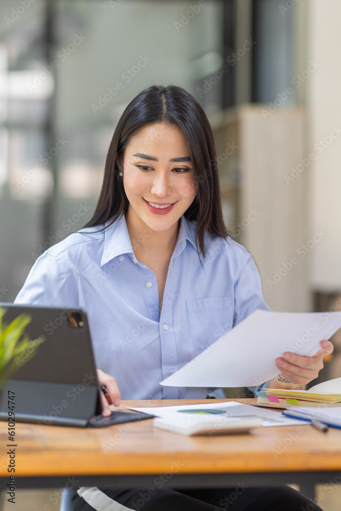 Asian Business woman using calculator and laptop for doing math finance on an office desk, tax, report, accounting, statistics, and analytical research concept
Asian Business woman using calculator and laptop for doing math finance on an office desk, tax, report, accounting, statistics, and analytical research concept
