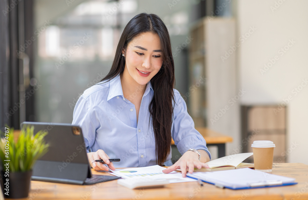 Asian Business woman using calculator and laptop for doing math finance on an office desk, tax, report, accounting, statistics, and analytical research concept
Asian Business woman using calculator and laptop for doing math finance on an office desk, tax, report, accounting, statistics, and analytical research concept