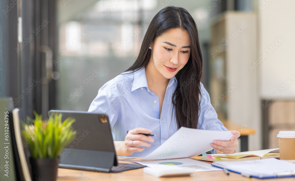 Asian Business woman using calculator and laptop for doing math finance on an office desk, tax, report, accounting, statistics, and analytical research concept
Asian Business woman using calculator and laptop for doing math finance on an office desk, tax, report, accounting, statistics, and analytical research concept