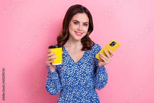 Photo of gorgeous cheerful lady hold smart phone order coffee cup online isolate Fototapet