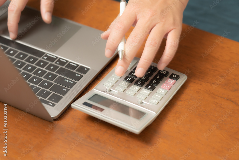 The dedicated businessman is multitasking with utmost precision, effortlessly maneuvering his laptop, mobile phone, and calculator to streamline his business operations and make informed decisions. The dedicated businessman is multitasking with utmost precision, effortlessly maneuvering his laptop, mobile phone, and calculator to streamline his business operations and make informed decisions.