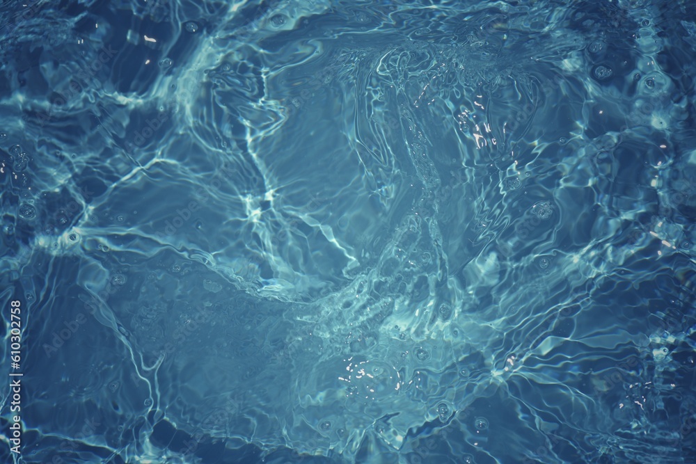 Blue water with ripples on the surface. Defocus blurred transparent blue colored clear calm water surface texture with splashes and bubbles. Water waves with shining pattern texture background. Blue water with ripples on the surface. Defocus blurred transparent blue colored clear calm water surface texture with splashes and bubbles. Water waves with shining pattern texture background.
