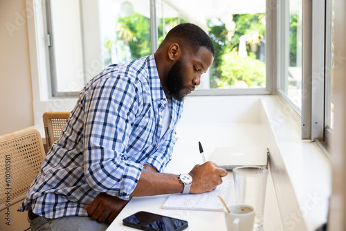 Young Black Man Working On The Calendar Schedule Agenda Or Organizer