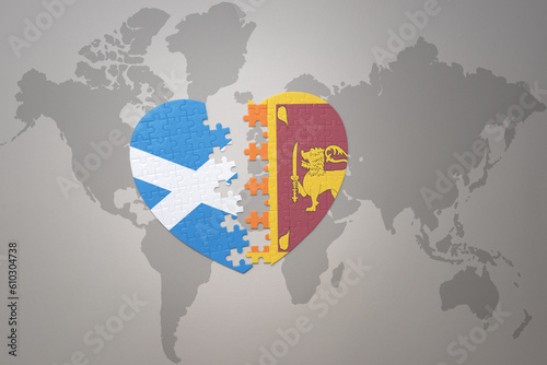 puzzle heart with the national flag of sri lanka and scotland on a world map background.Concept.
