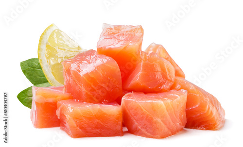 Pile of trout cubes with leaves and lemon close-up on a white. isolated