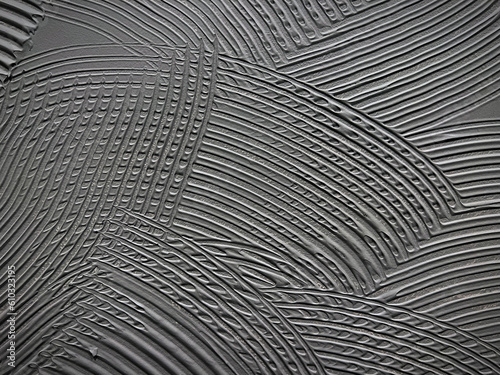 Gray wall glue plaster comb surface prepared for tiling. Tile adhesive notched trowel patterns. Adhesive background. Cement wall