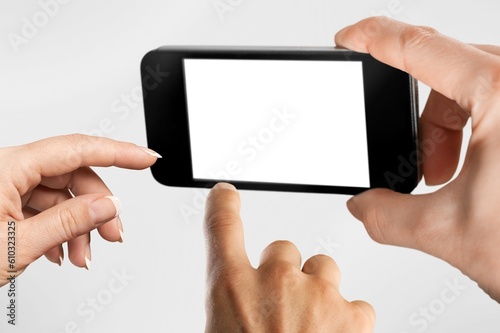Human holding smartphone with white blank screen