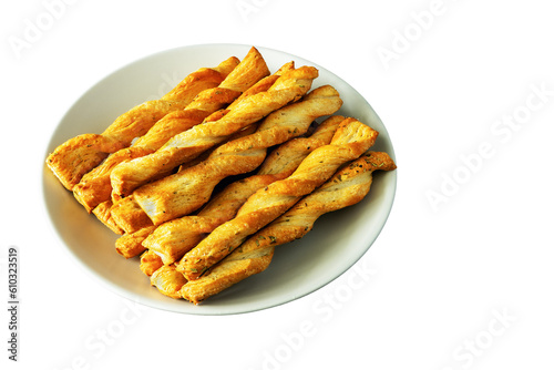 Sticks of buttery yeast dough on a plate on a white background