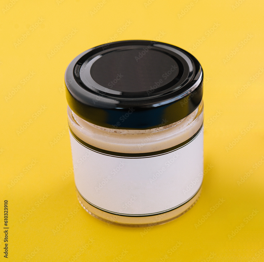 salad dressings in glass jar on yellow background